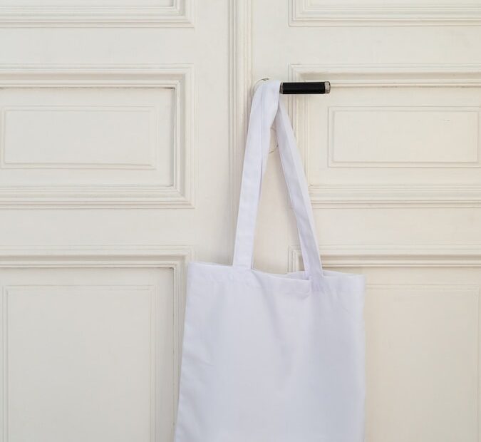 a white bag hanging on a white door